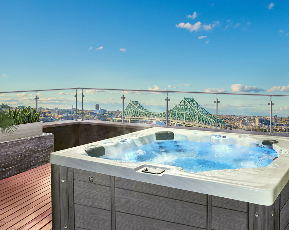 A luxurious rooftop terrace featuring a steaming hot tub Trevi Balneo 5000, with panoramic city views. The spa is surrounded by a wooden deck and glass railings