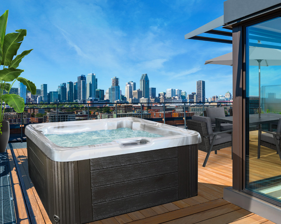 A Trevi Sky spa on a rooftop terrace with a city skyline view, demonstrating its portability and suitability for urban environments