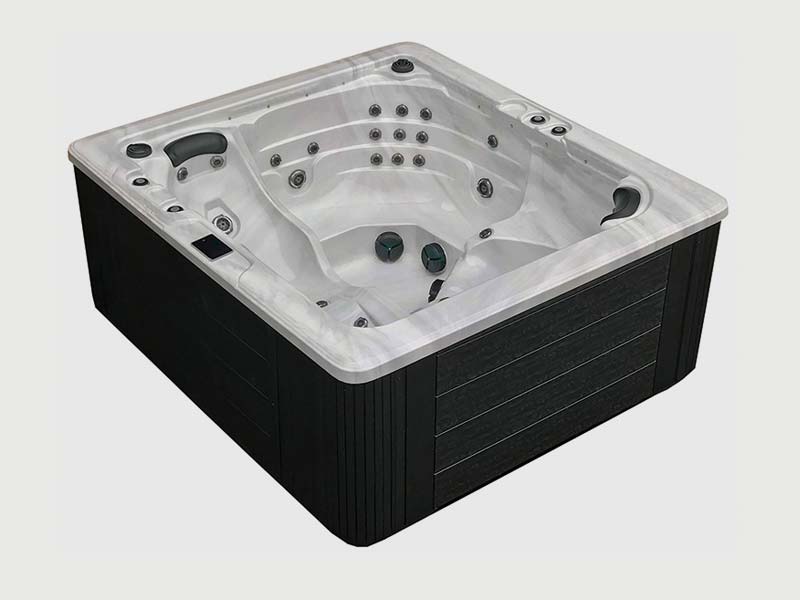 A luxurious square hot tub from Trevi, manufactured by Dynasty Spas. The spa features a white interior with molded seats and numerous jets. The exterior has a sleek black finish with a wood-grain texture.