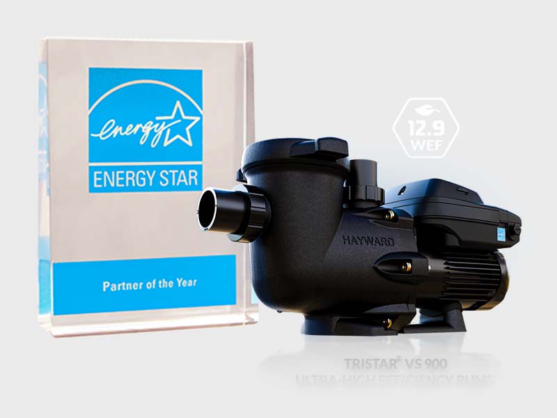 A Hayward TriStar VS 900 pool pump displayed next to an ENERGY STAR Partner of the Year award. The pump is black with blue accents and features a 12.9 WEF (Weighted Energy Factor) rating, highlighting its energy efficiency.